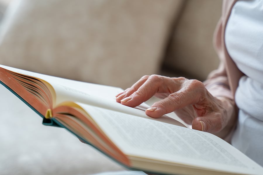 bigstock-Elderly-Woman-Reading-The-Book-434252636