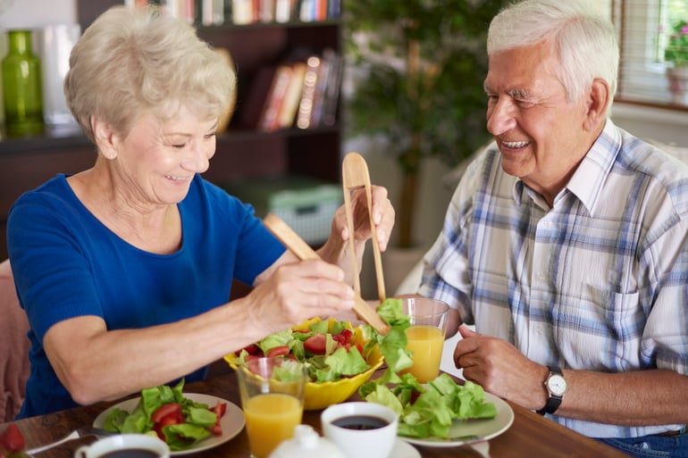 seniors enjoying a healthy meal (salad) together