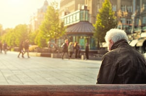 old man on bench in city